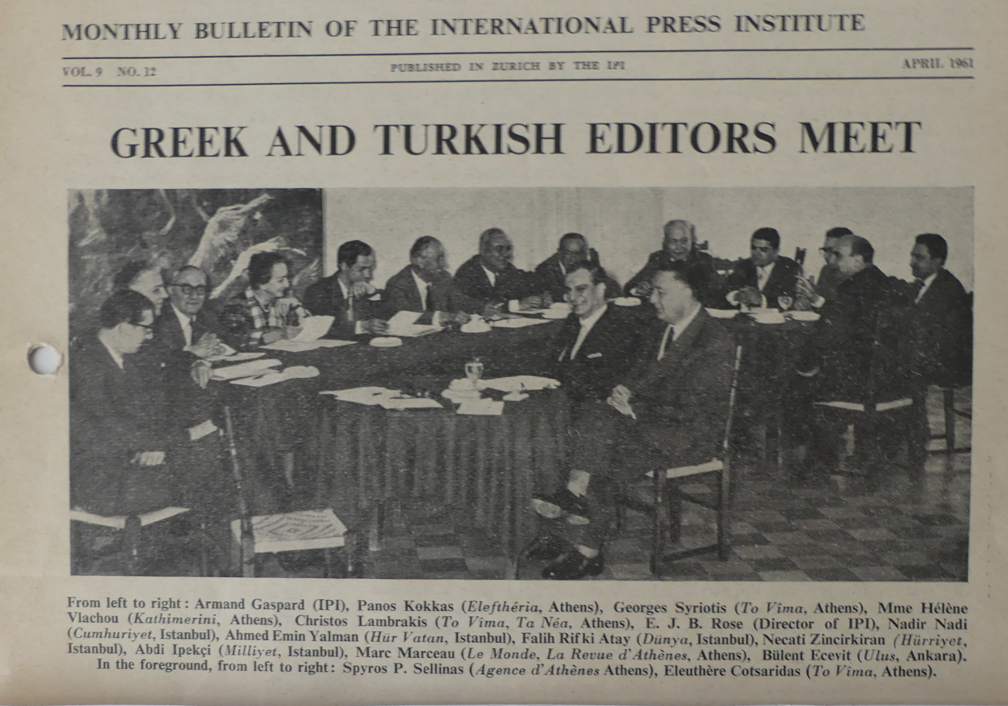 16 people sitting around a semi-circular arrangement of tables